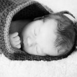 black and white sleepy newborn