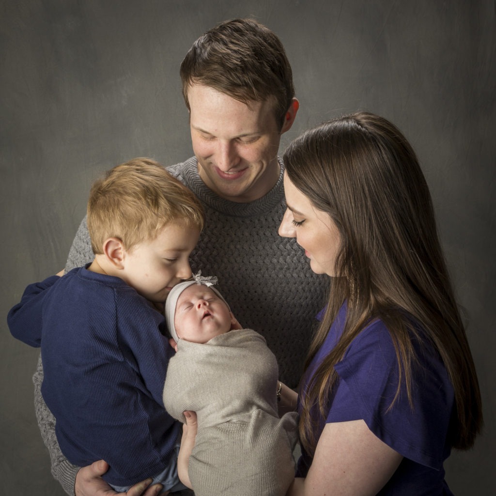 family poses for newborn portrait Charlotte, NC
