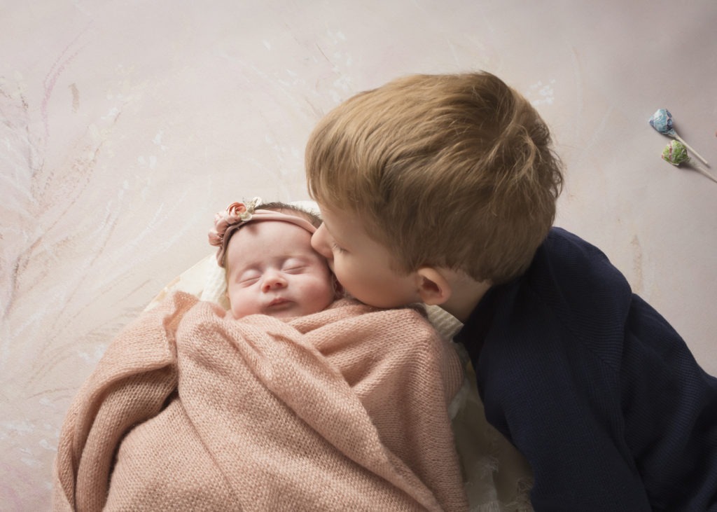 We sometimes can use bribes to get the perfect shot. newborn with sibling Charlotte, NC