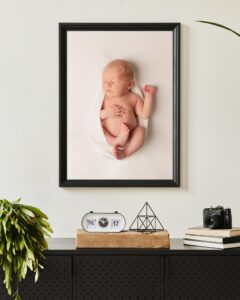 newborn portrait with baby wrapped in white and framed in Charlotte NC.