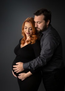 couple poses for maternity portrait