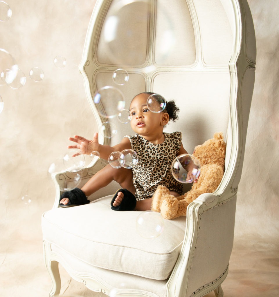 family portrait session with little girl and bubbles