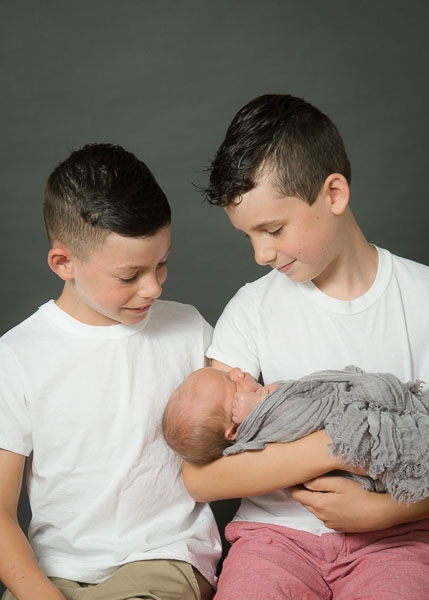 relaxing newborn portrait with brothers