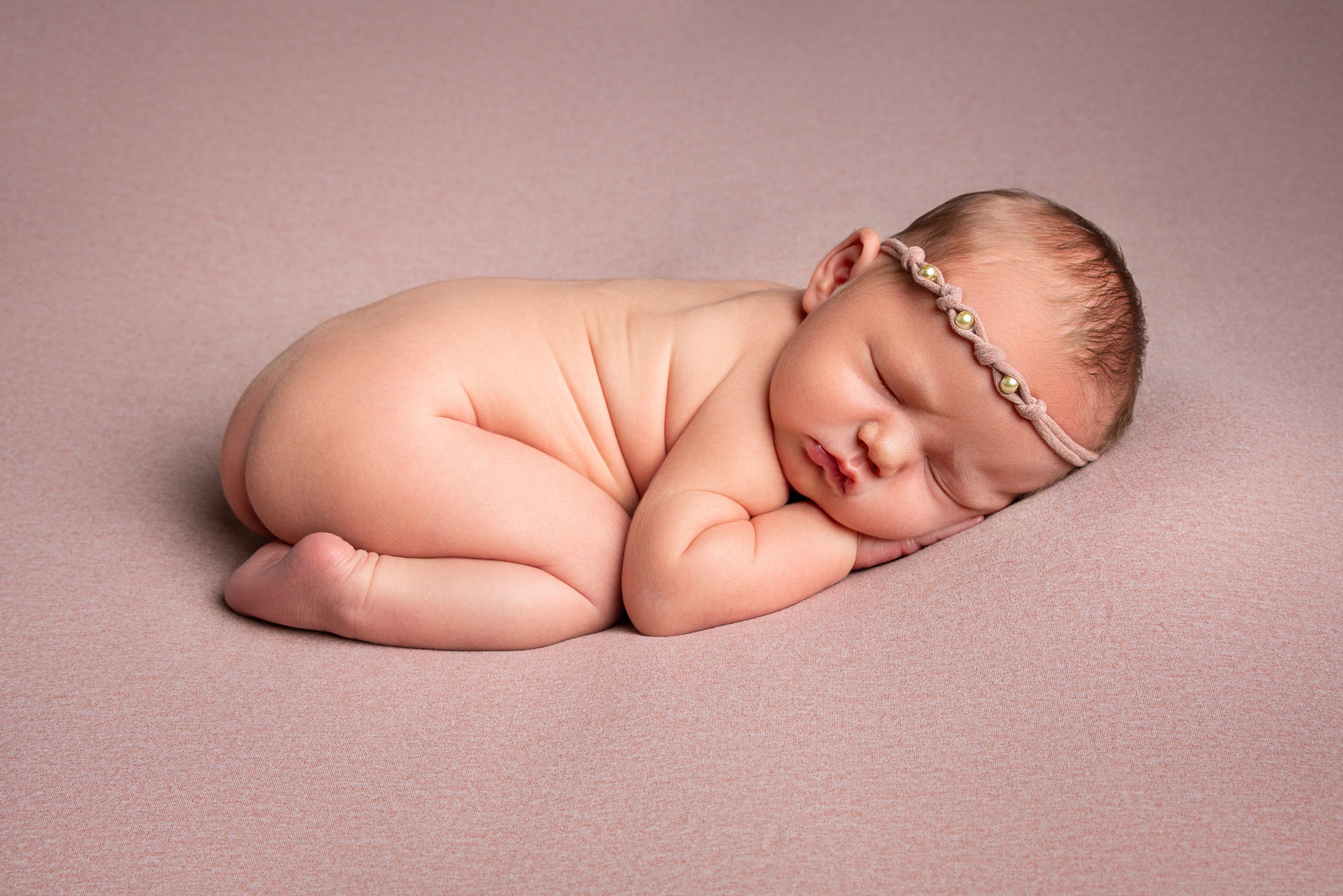 sweet newborn girl poses for her newborn portrait session