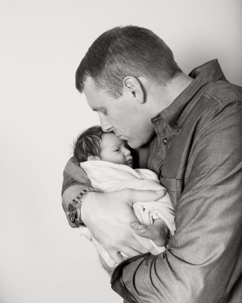 infant safe in daddy's arms