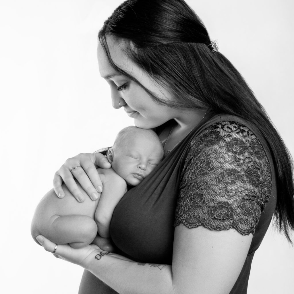 Charlotte mama holds her sweet newborn during a newborn portrait session