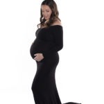 Capturing the Beauty of Motherhood With A Sentimental Pregnancy Gift, Charlotte Maternity Portrait, beautiful mother to be in a black gown on a white background including an angel chime pendant to symbolize baby's Italian heritage