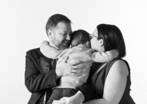 formal family photo captures a hug, motherhood photography example