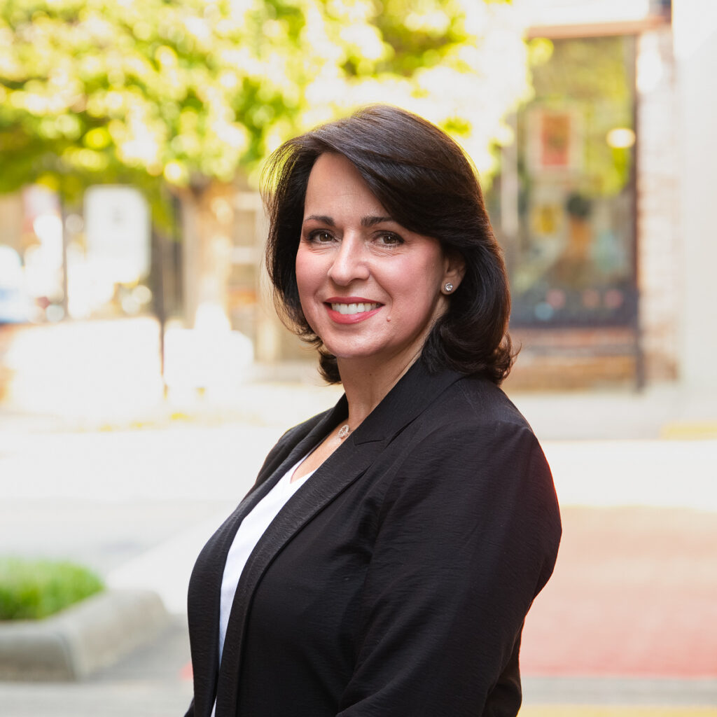 Main street Fort Mill SC woman posing in profile for her professional portrait. Created by Insley Photography for the FMEP board 2024