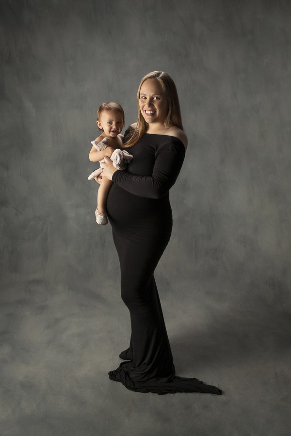 mom holding her child during maternity portrait