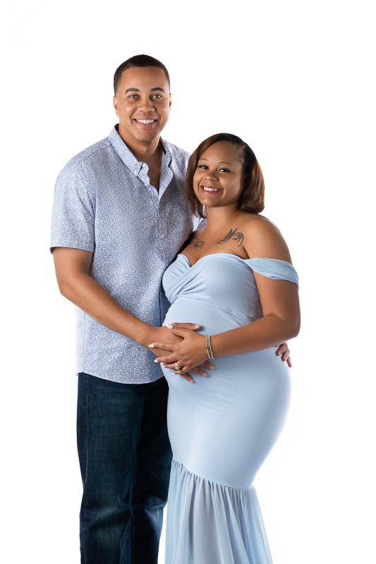 Couple posing for their studio maternity session