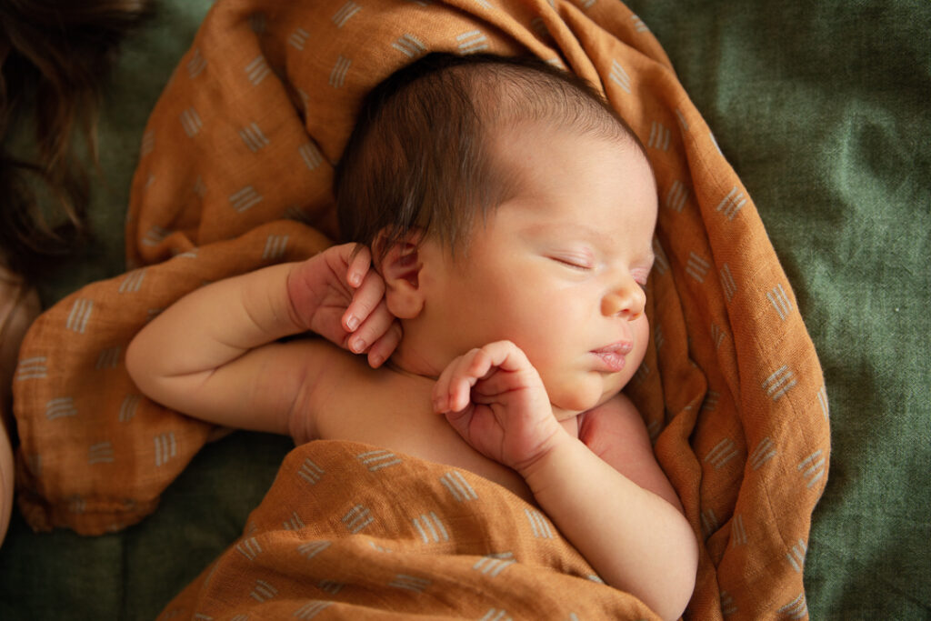 relaxed and natural pose of a newborn baby sleeping peacefully for her In-Home Newborn Portraits in Charlotte & Fort Mill
