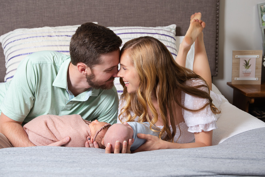 Charlotte newborn Portraits baby girl newborn boy twins with parents, photographed in home on a bed, in color two wrapped babies, when to schedule newborn photography, Fort Mill SC